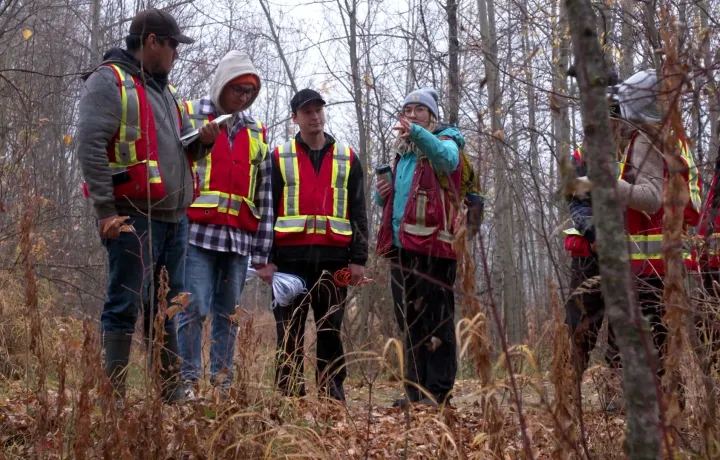 Group in woods during forest carbon training at the Kikino Metis Settlement